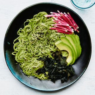 Wheat noodles tossed in matcha powder soy sauce and rice wine vinegar and served with wakame sliced avocado and...