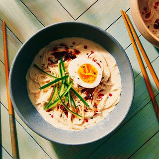 Cold Soy Milk Noodles in a grey bowl on a turquoise wooden surface